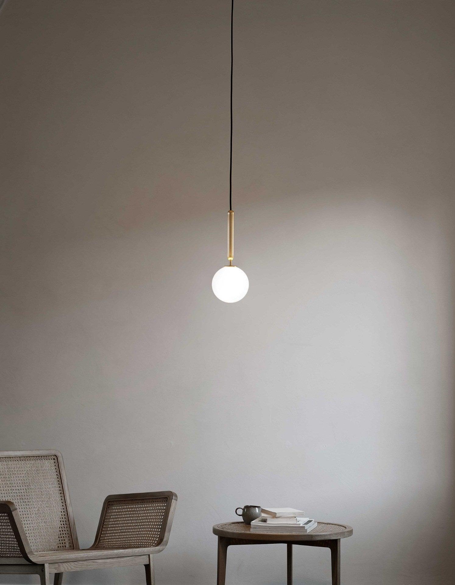 White globe pendant above a small side table