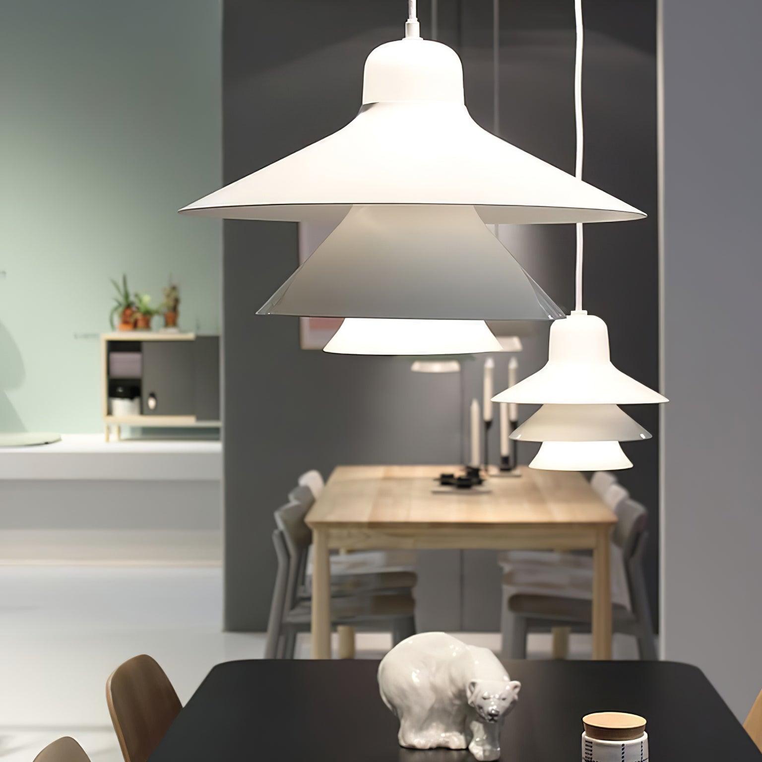 Pair of White layered pendants in a dining area