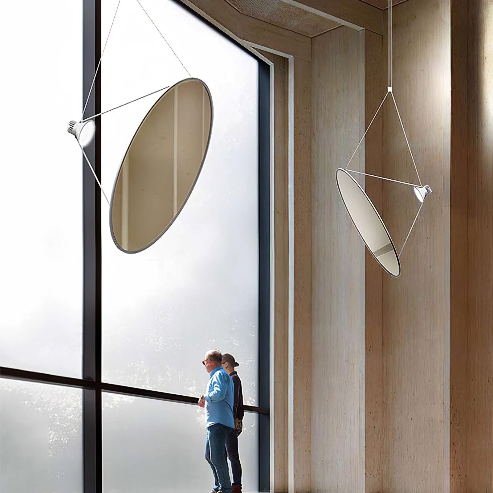 Large disc pendants in a tall windowed interior