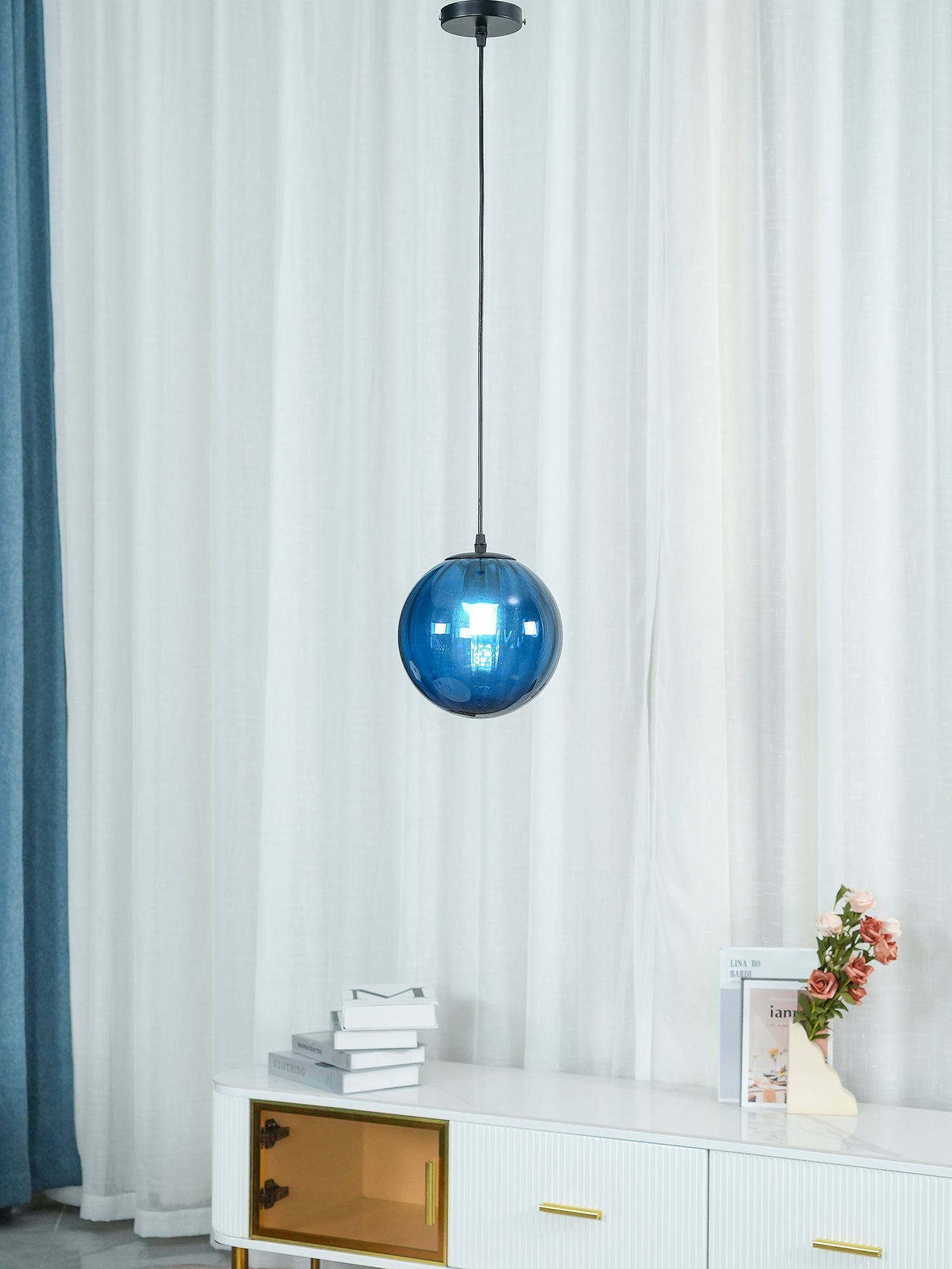 Paola pendant light with a coloured glass globe and small metal cap