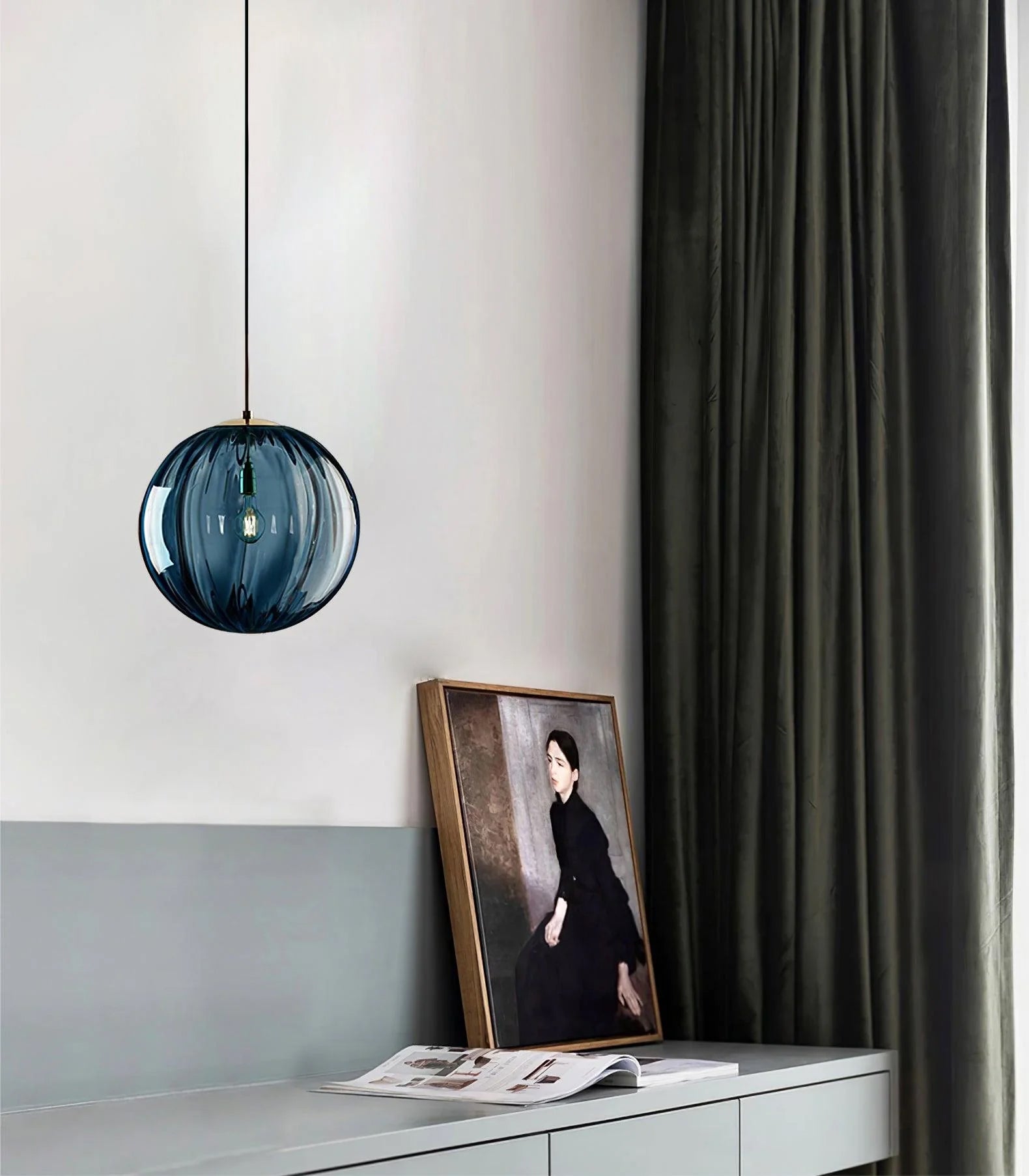 Paola pendant light with a coloured glass globe and small metal cap