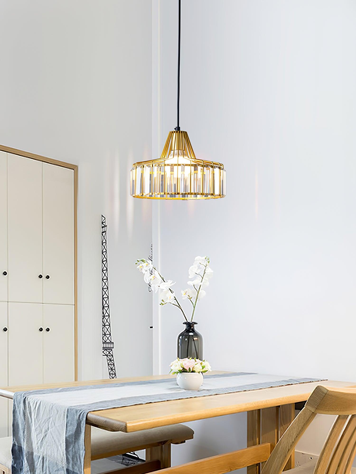 Gold-coloured drum pendant above a table and orchids