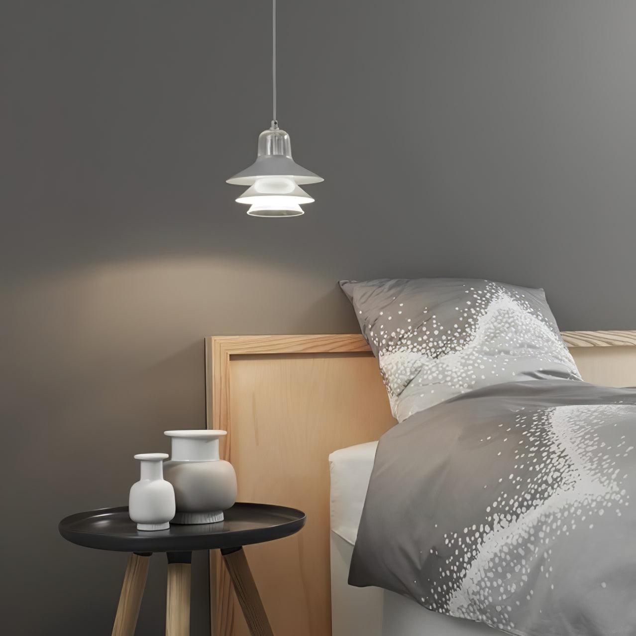 Small pendant beside a bed