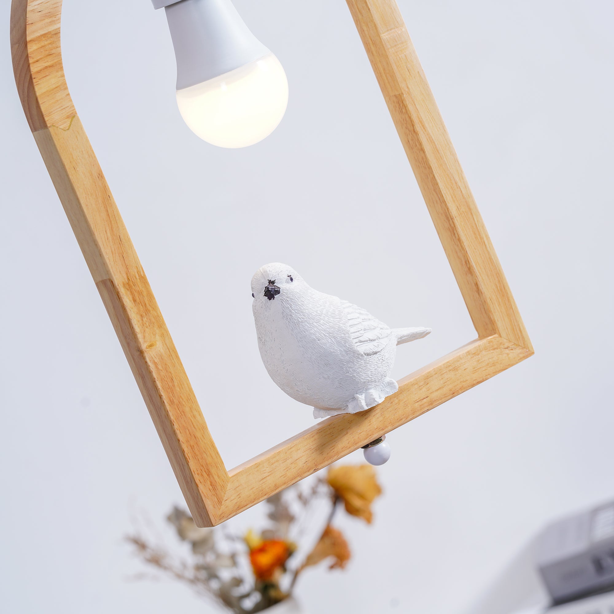 Angled bird figure and exposed bulb inside arch