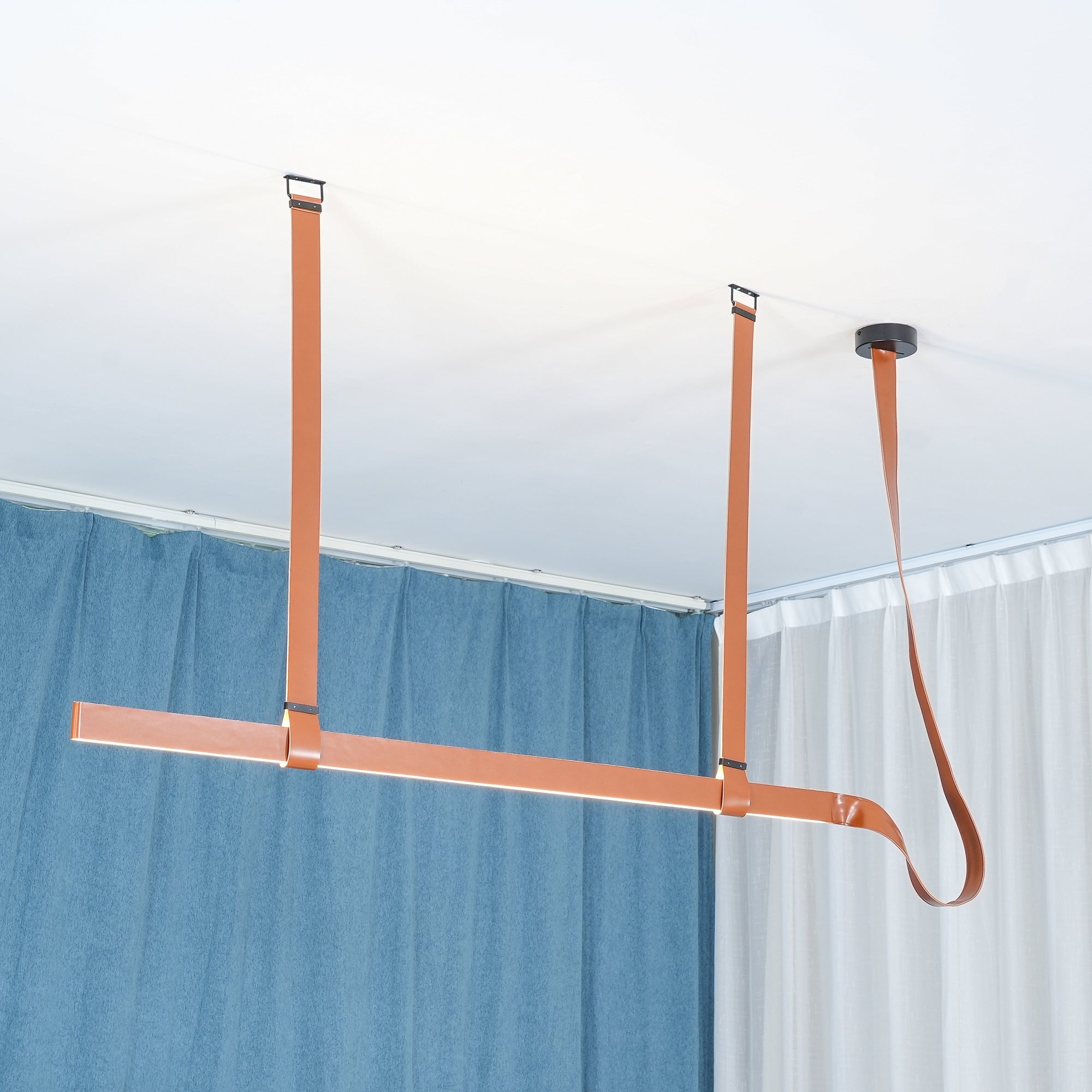 Brown straight profile and curved end near blue curtains
