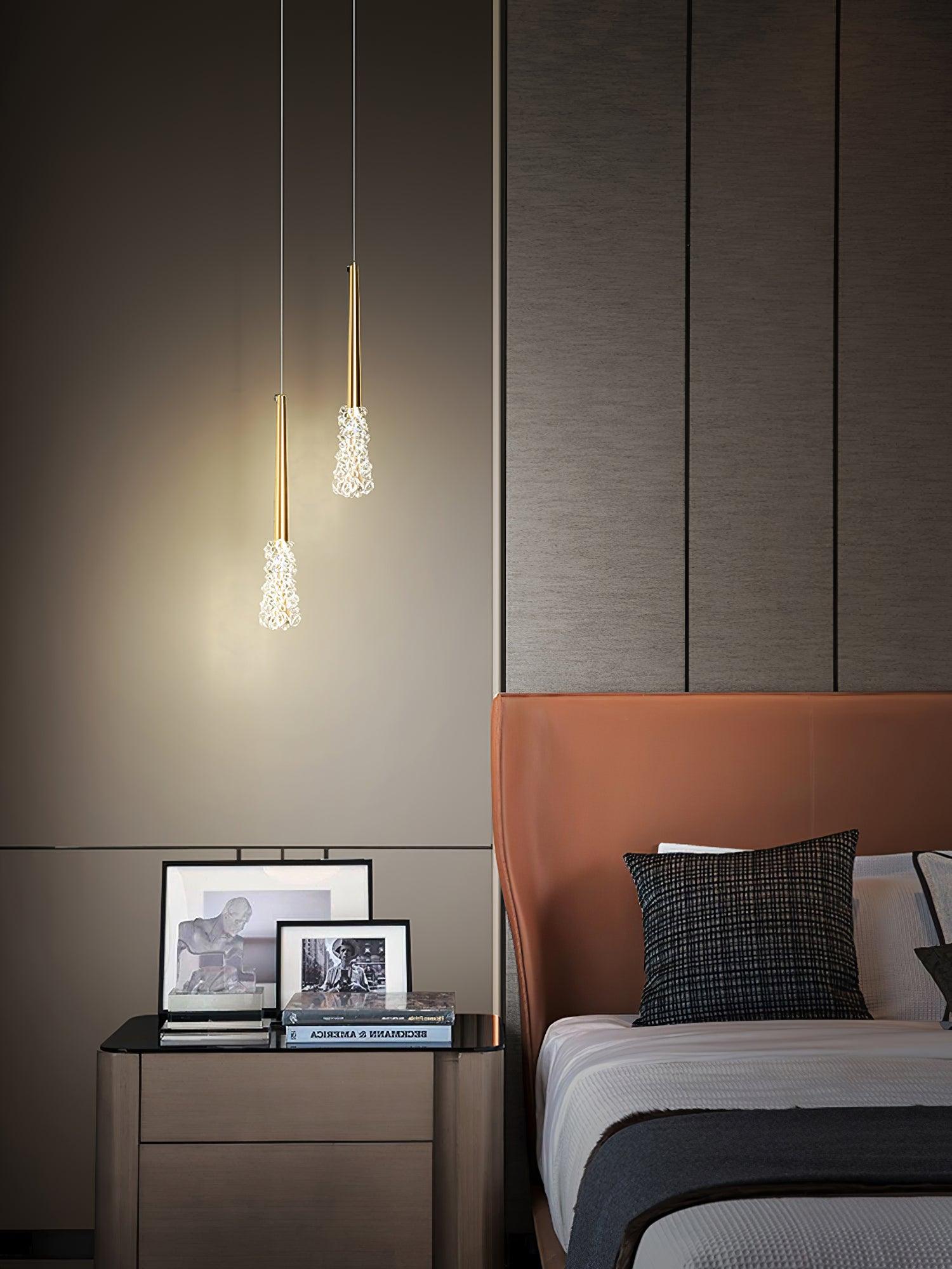 Textured clear pendant shades near a bedside display