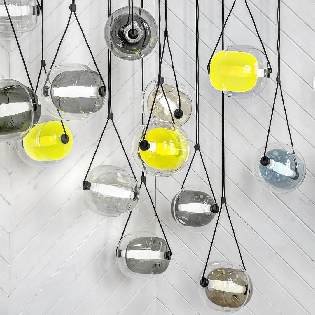Clear and yellow glass pendants suspended at varied heights