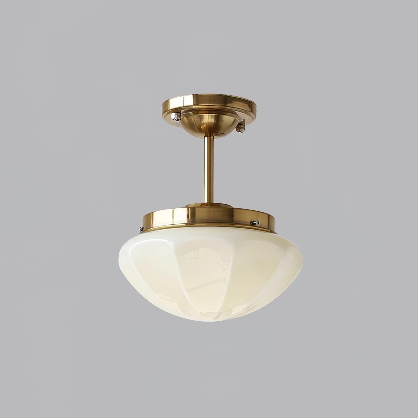 Gold-tone ceiling fitting with a longer stem and beige glass bowl