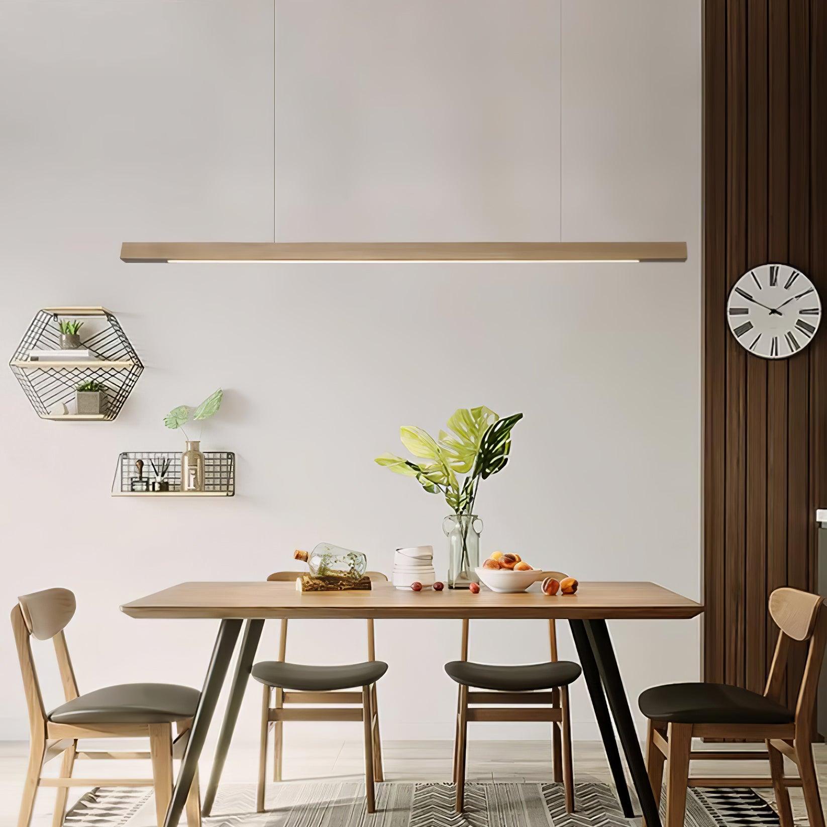Natural wood-colour pendant near dining-room greenery