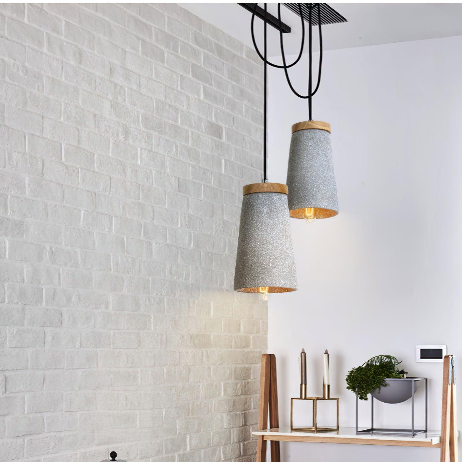 Grey cement pendants above a counter