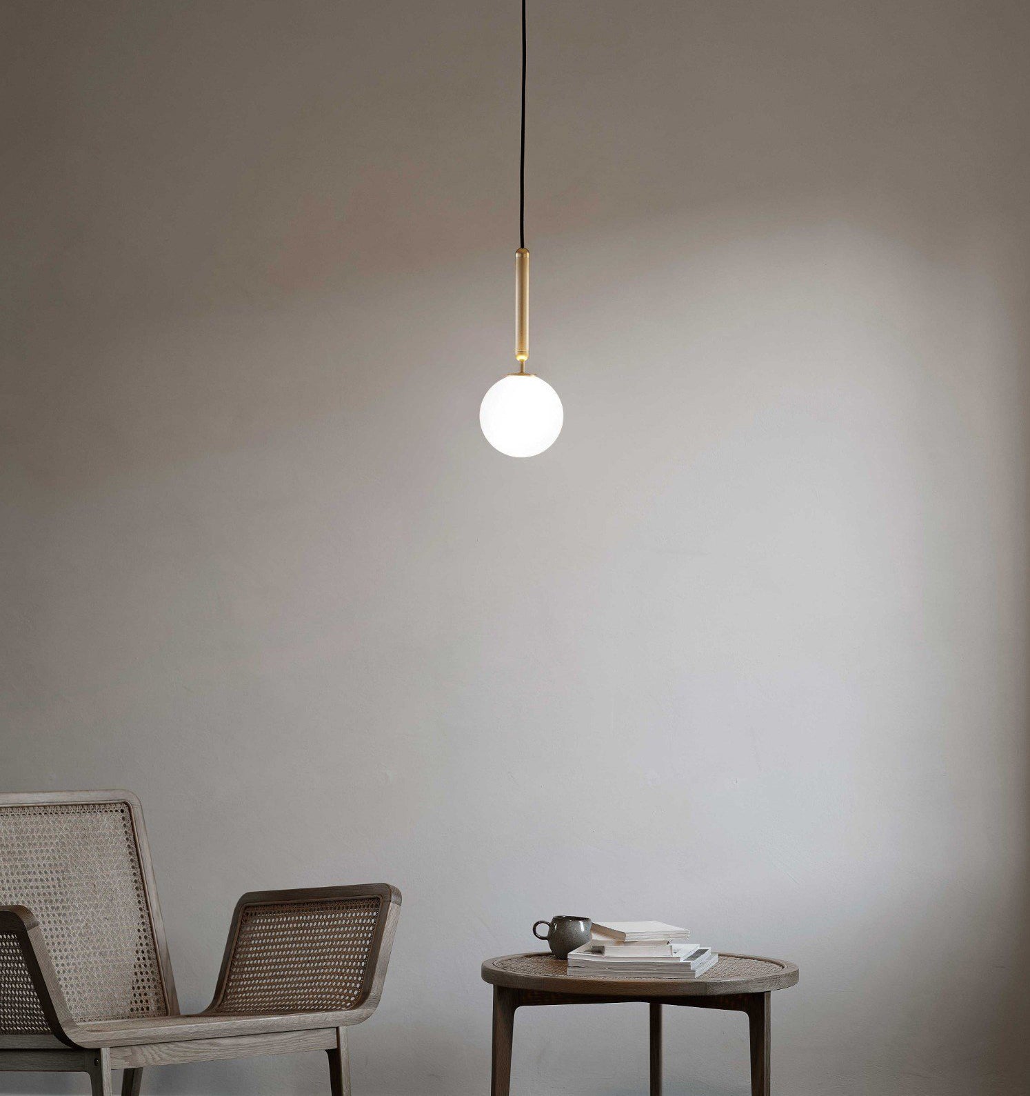 Single white globe with brass-coloured stem