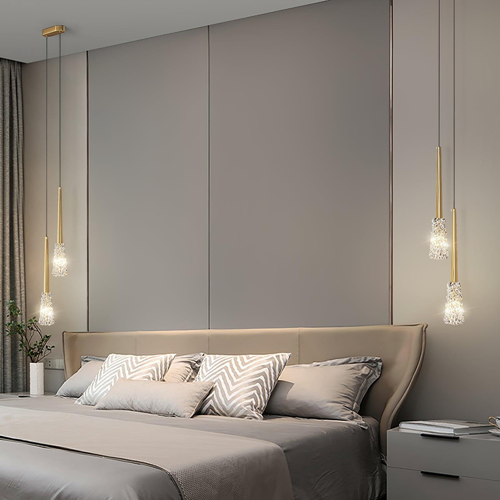 Paired clear-shade pendants in a pale bedroom