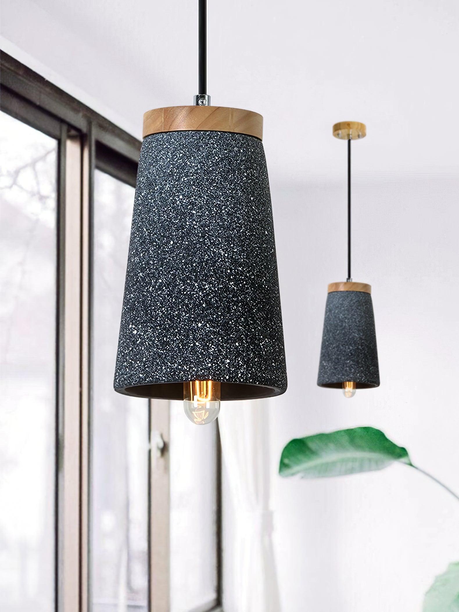 Two Black cement pendants beside a window