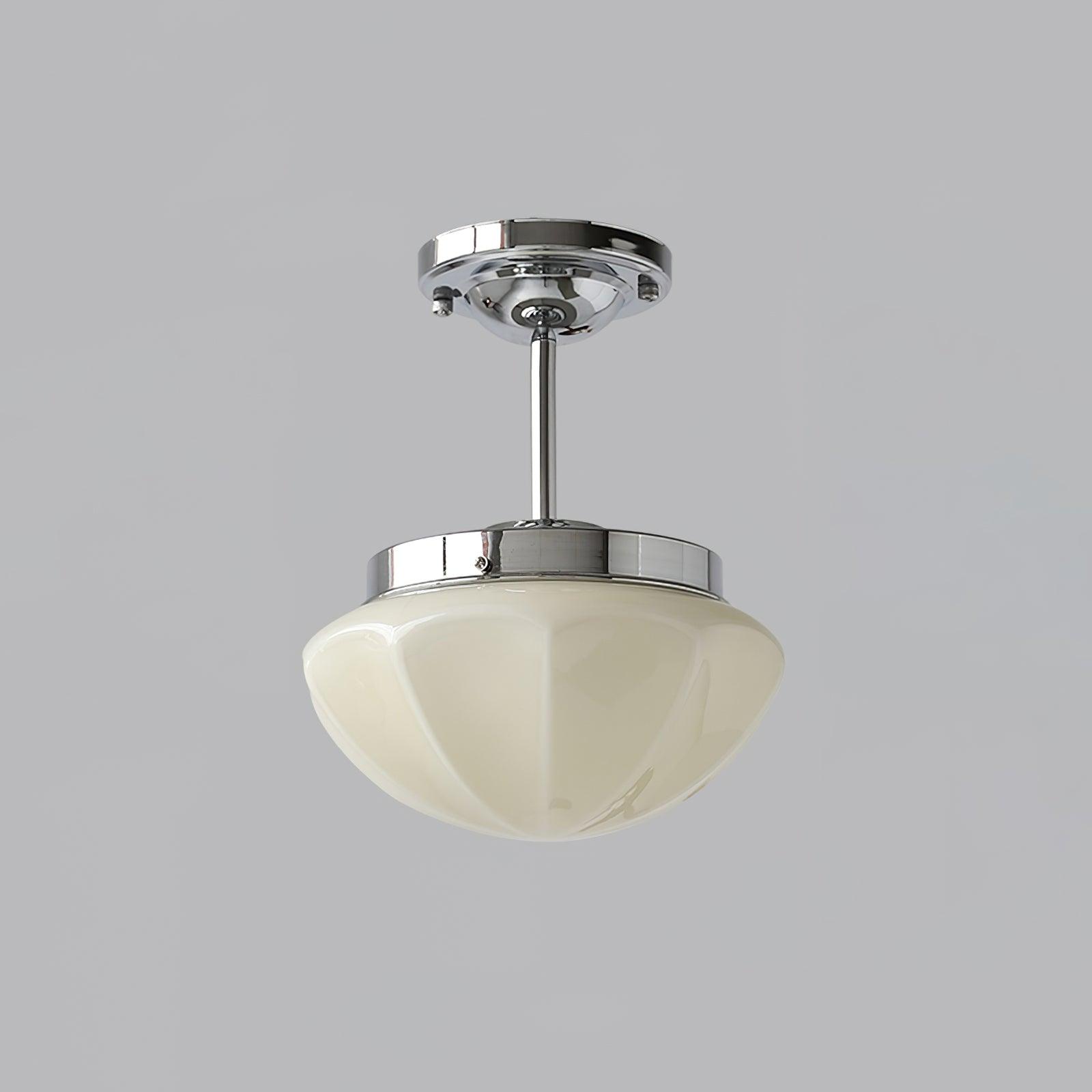 Beige faceted glass bowl below a silver cap and longer ceiling stem