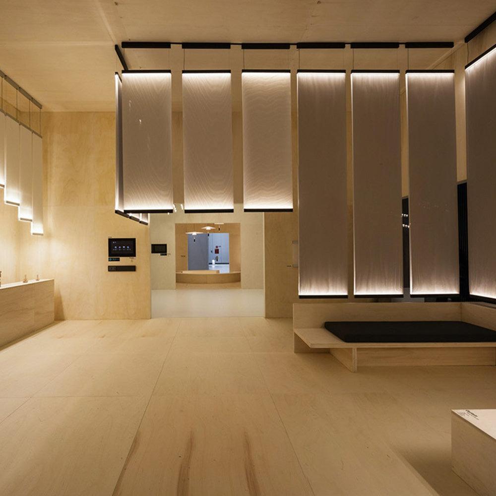 Tall fabric lights along an interior passage