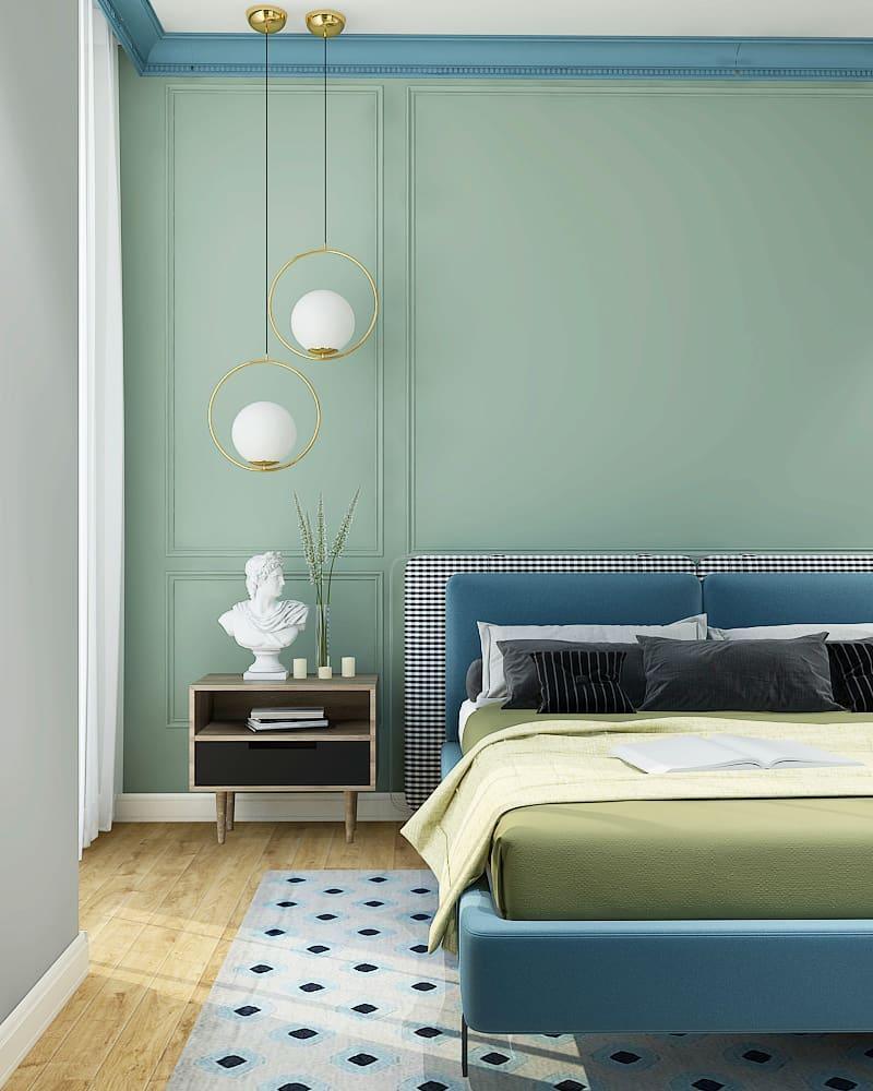 Two round frame globes beside a bed against a blue wall