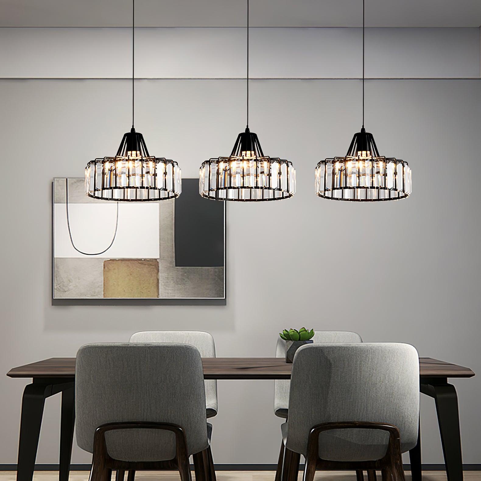 Three black drum pendants above a dining table