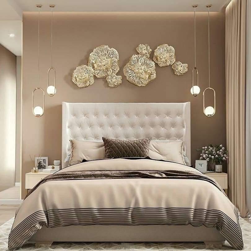 Frame-and-globe pendants on both sides of a bed