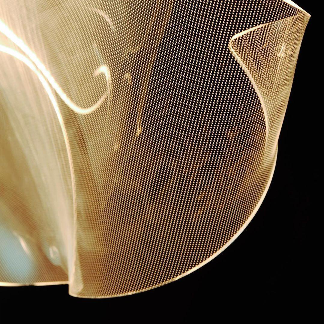 Close view of the fine dotted pattern and warm-lit acrylic edge