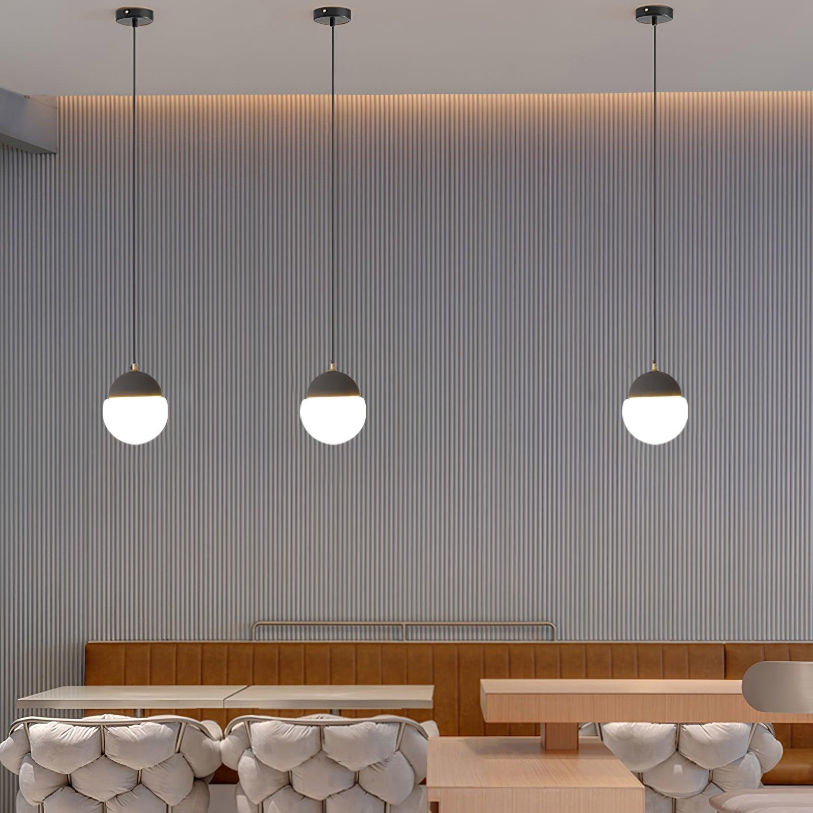 Three Cement Eclipse lights in a dining area