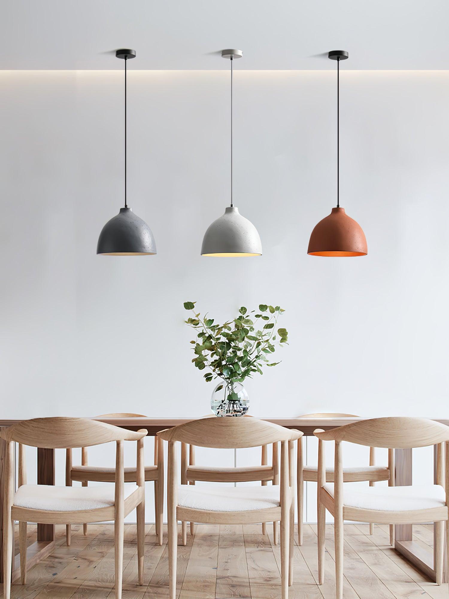 Three separate coloured pendants above a dining table
