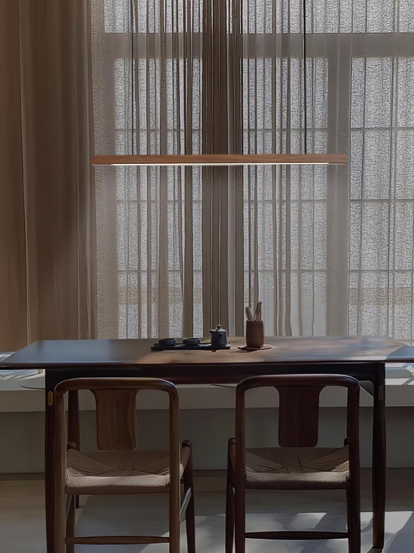 Walnut-colour bar pendant in a dark dining room
