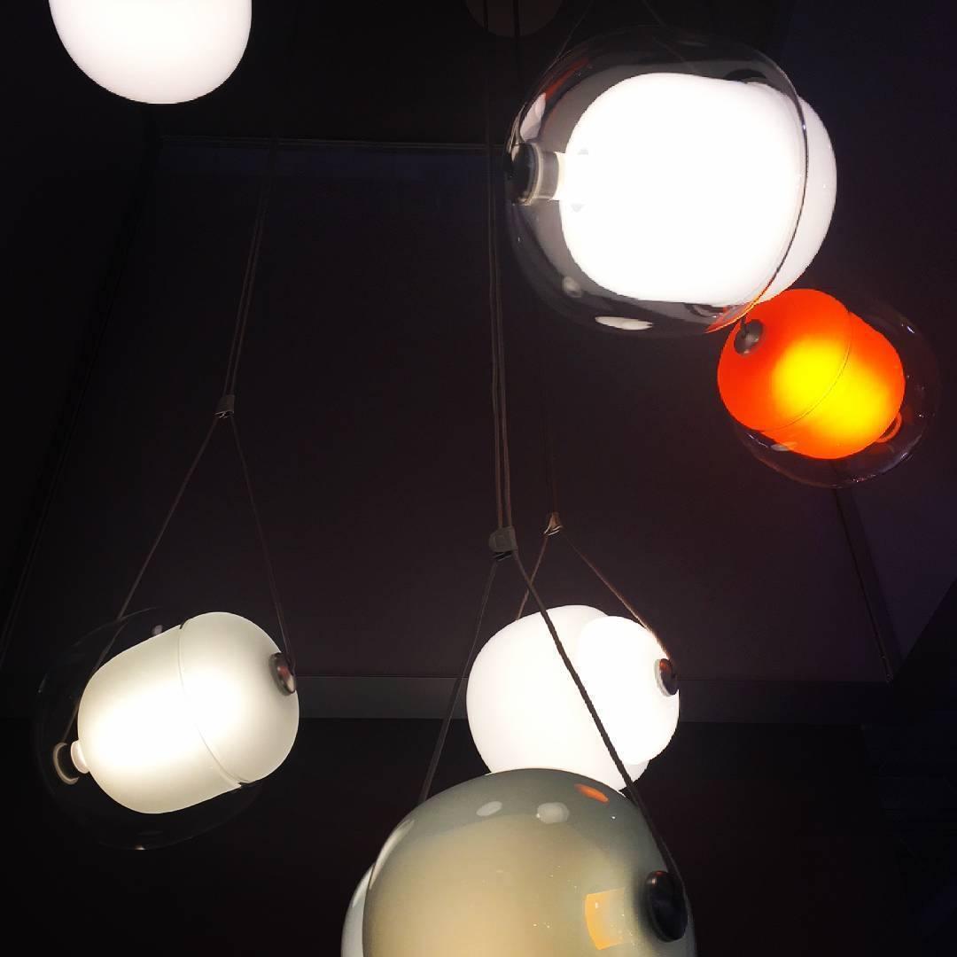 Grouped glowing glass capsules against a dark background