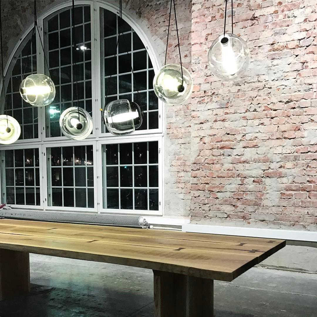 Clear glass pendants over a long wood table
