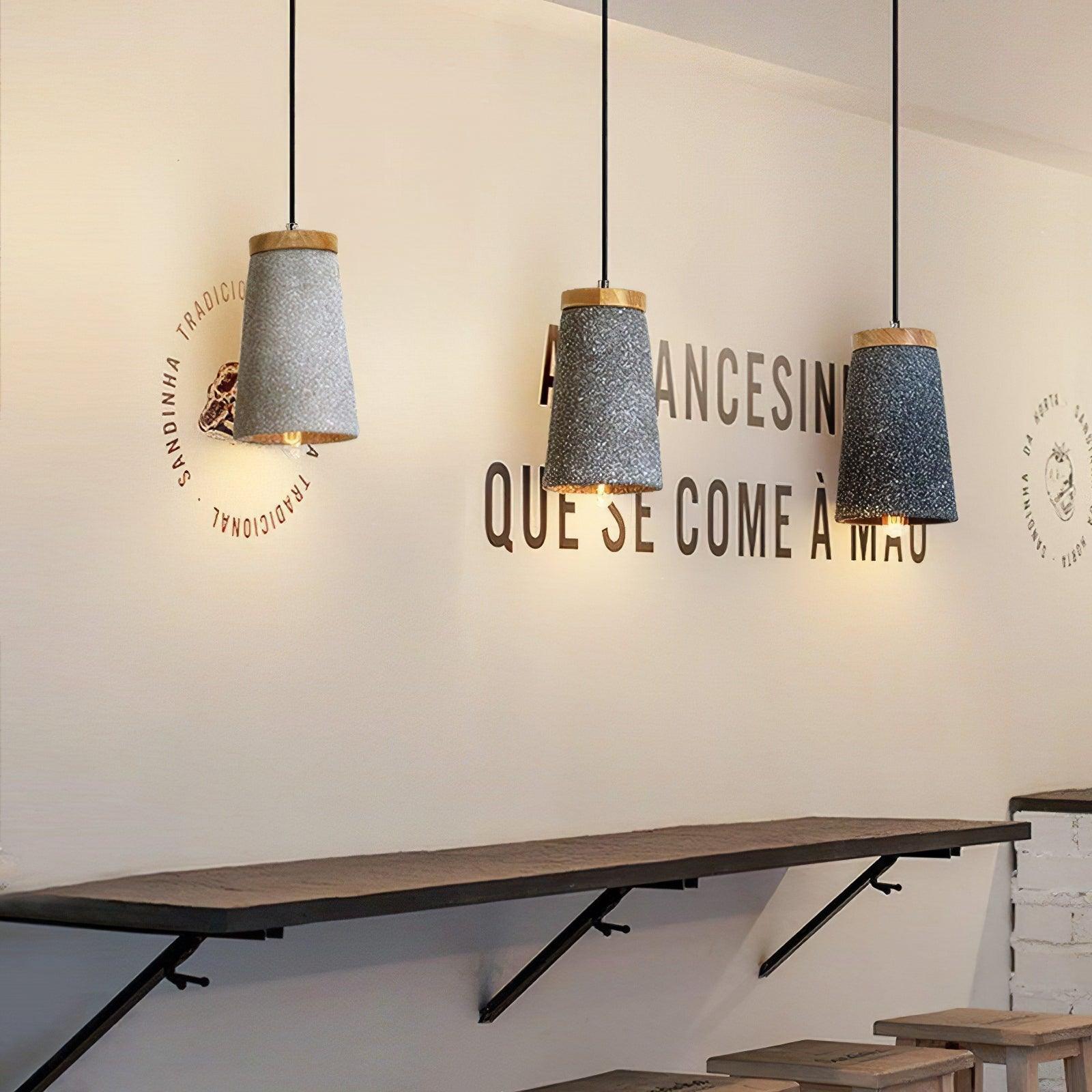 Three cement pendants in a café-style interior