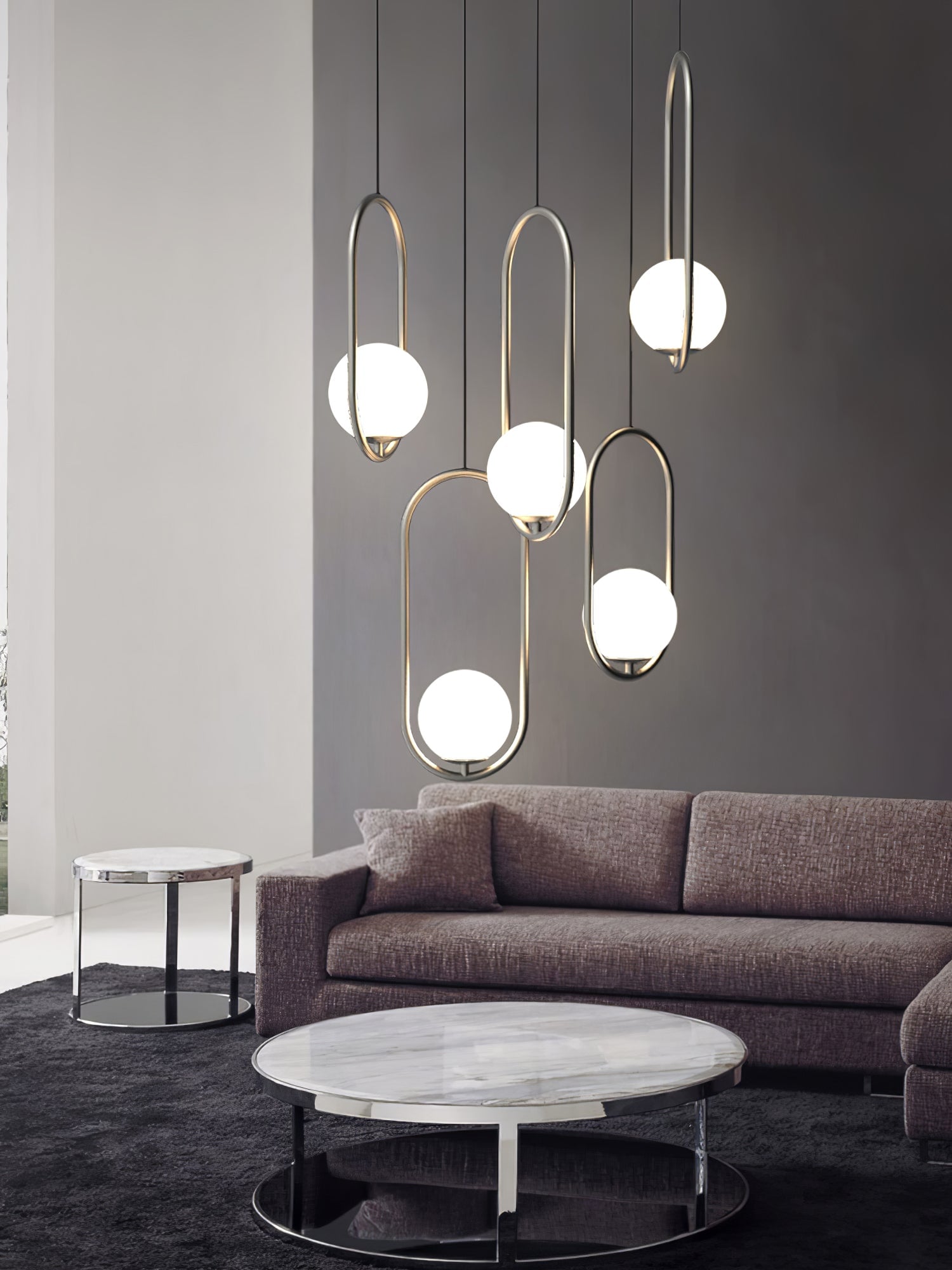Group of oval and circular pendants above a seating area