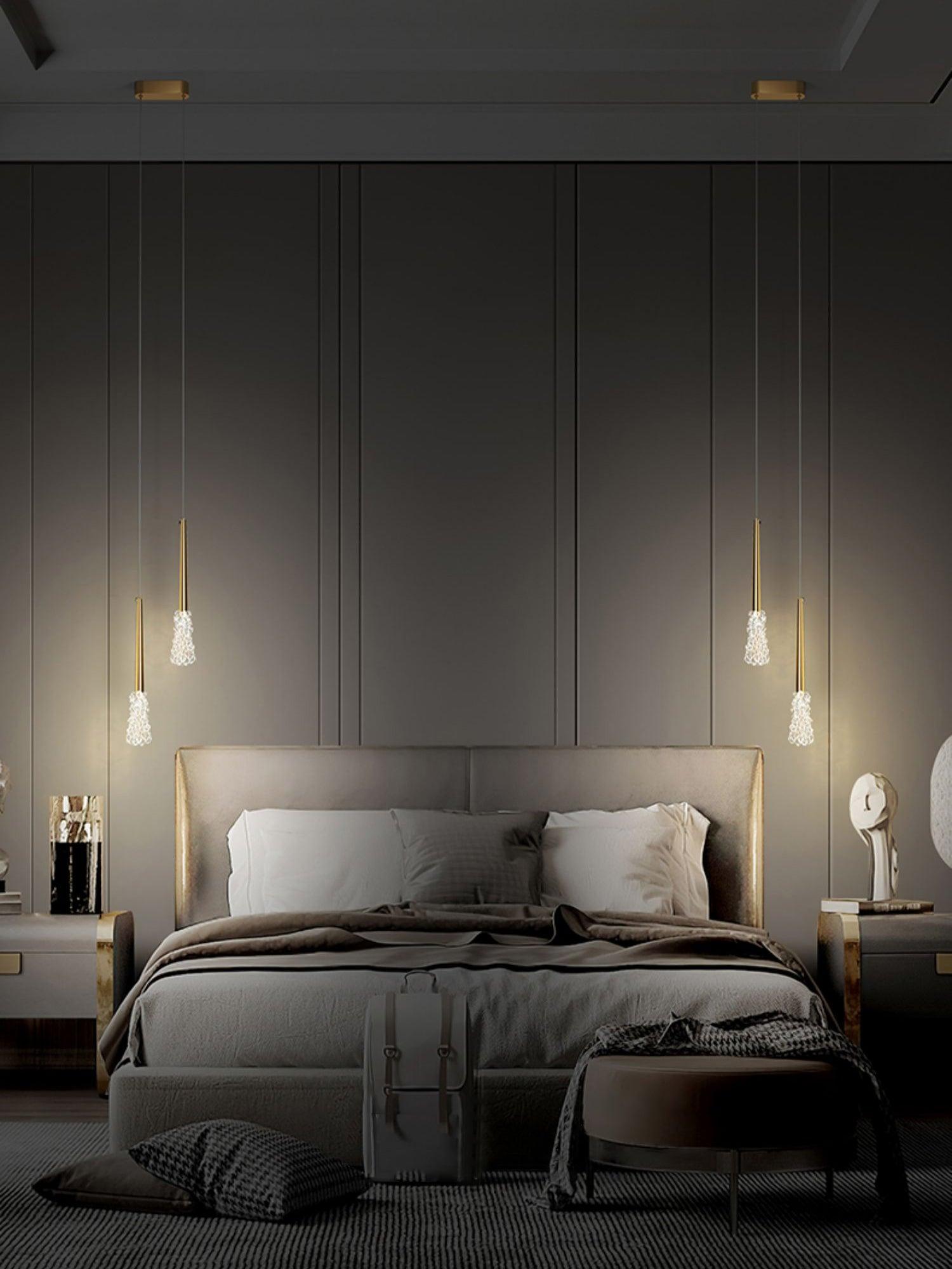 Paired pendants beside a grey bed