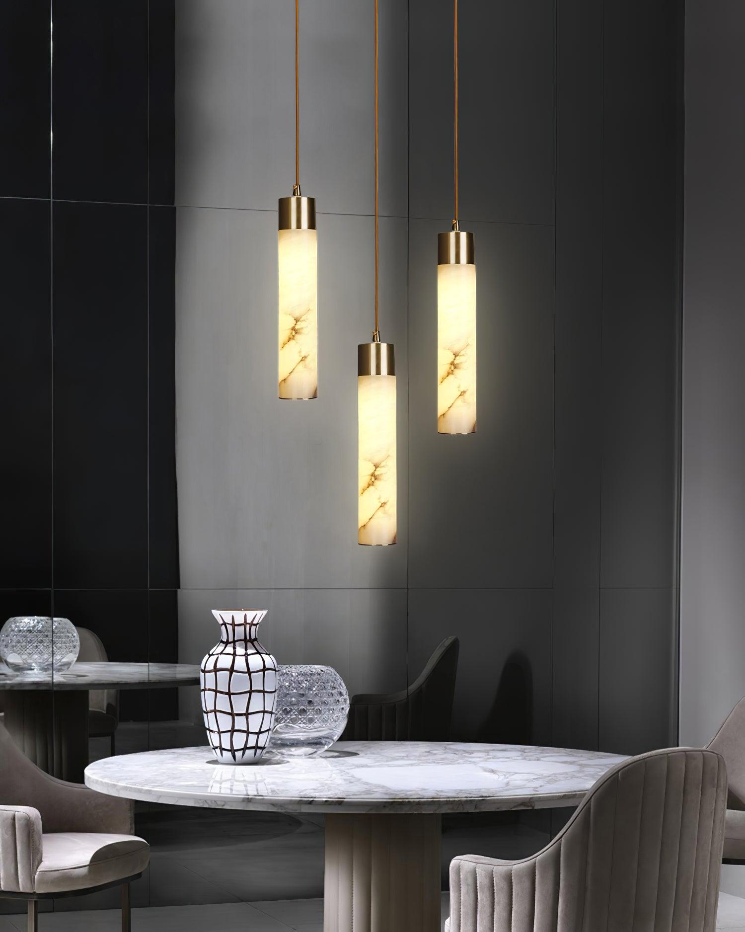 Three staggered alabaster pendants above a round table