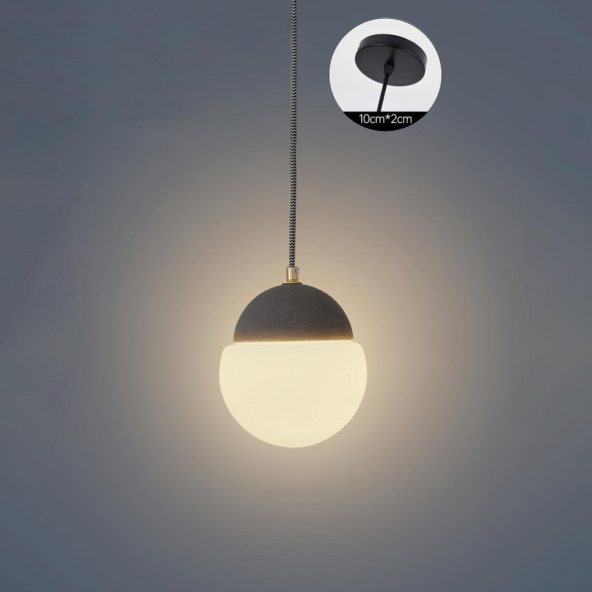 Sand black pendant against a Grey background