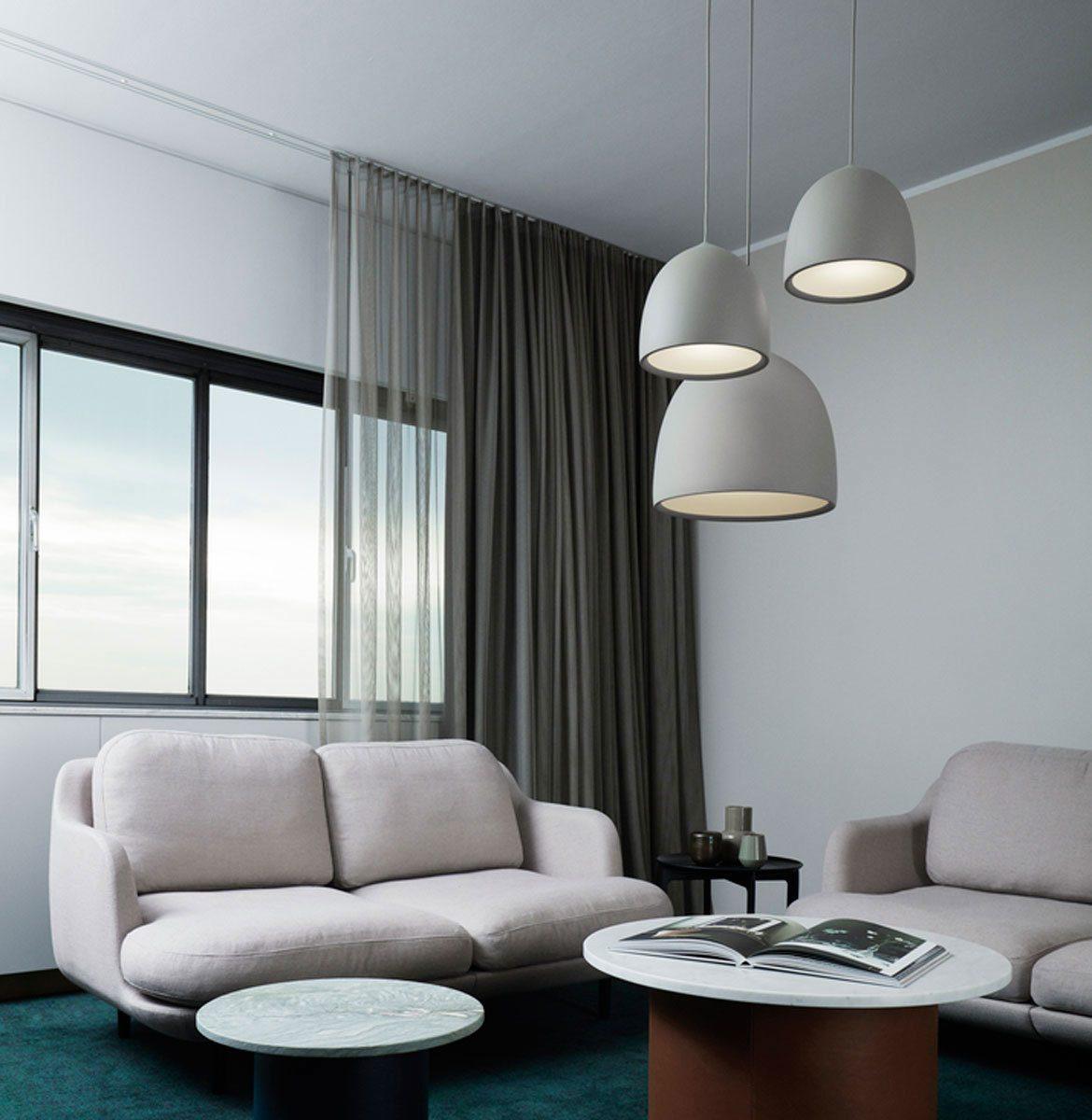 Pale bell pendants above a sofa seating area