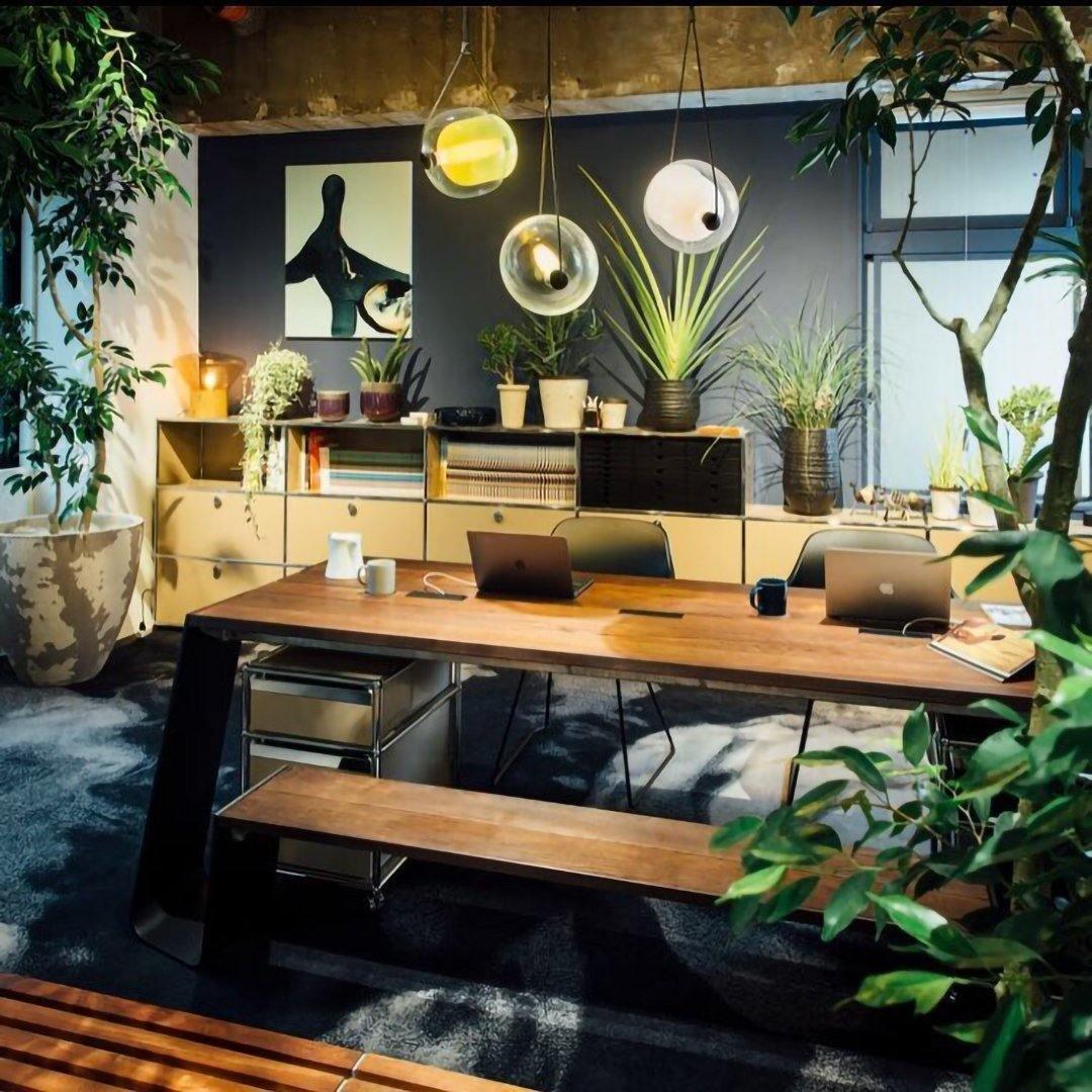 Yellow glass pendants among indoor plants
