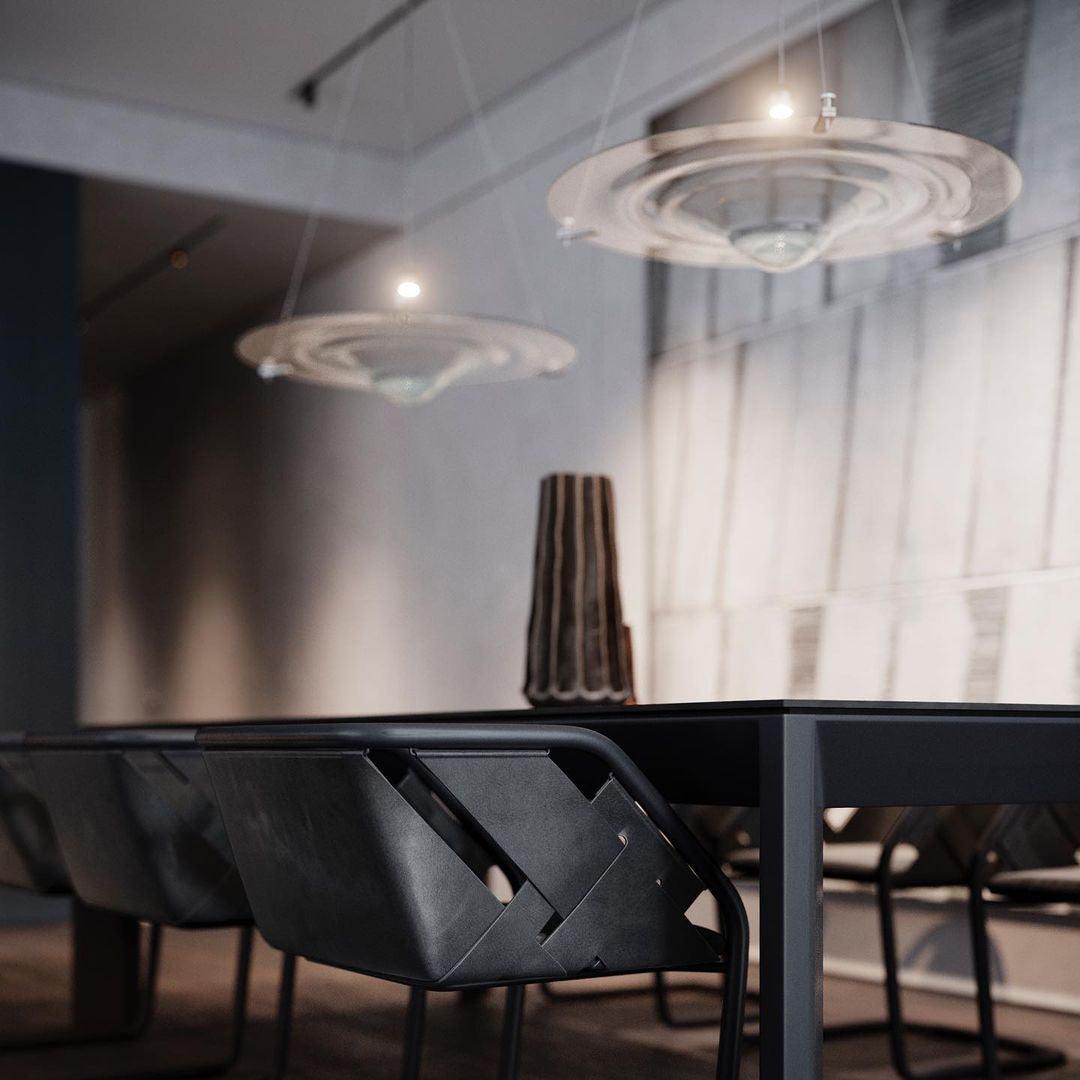 Glass disc pendants above a dark dining table