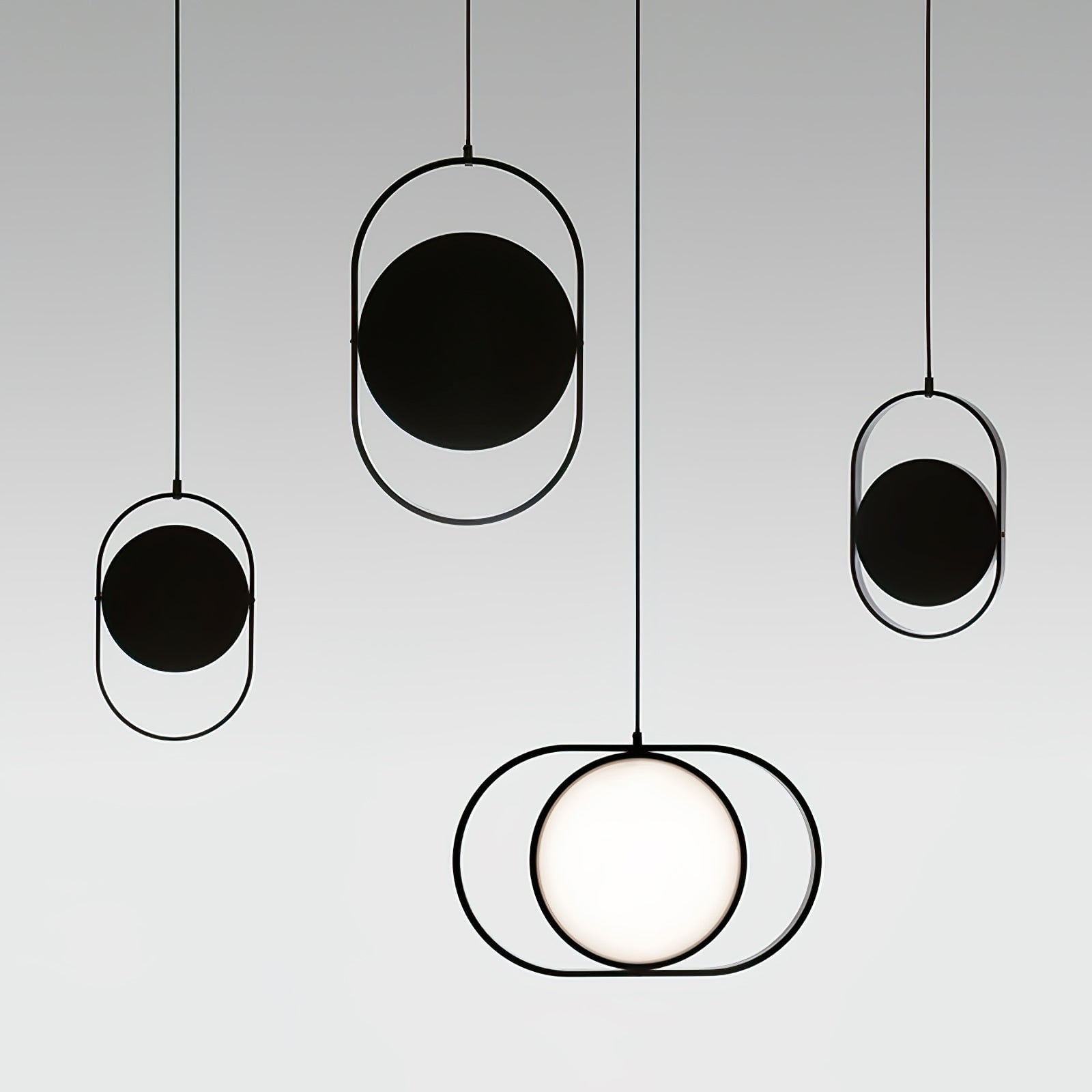 Black oval pendant group with dark disc backs