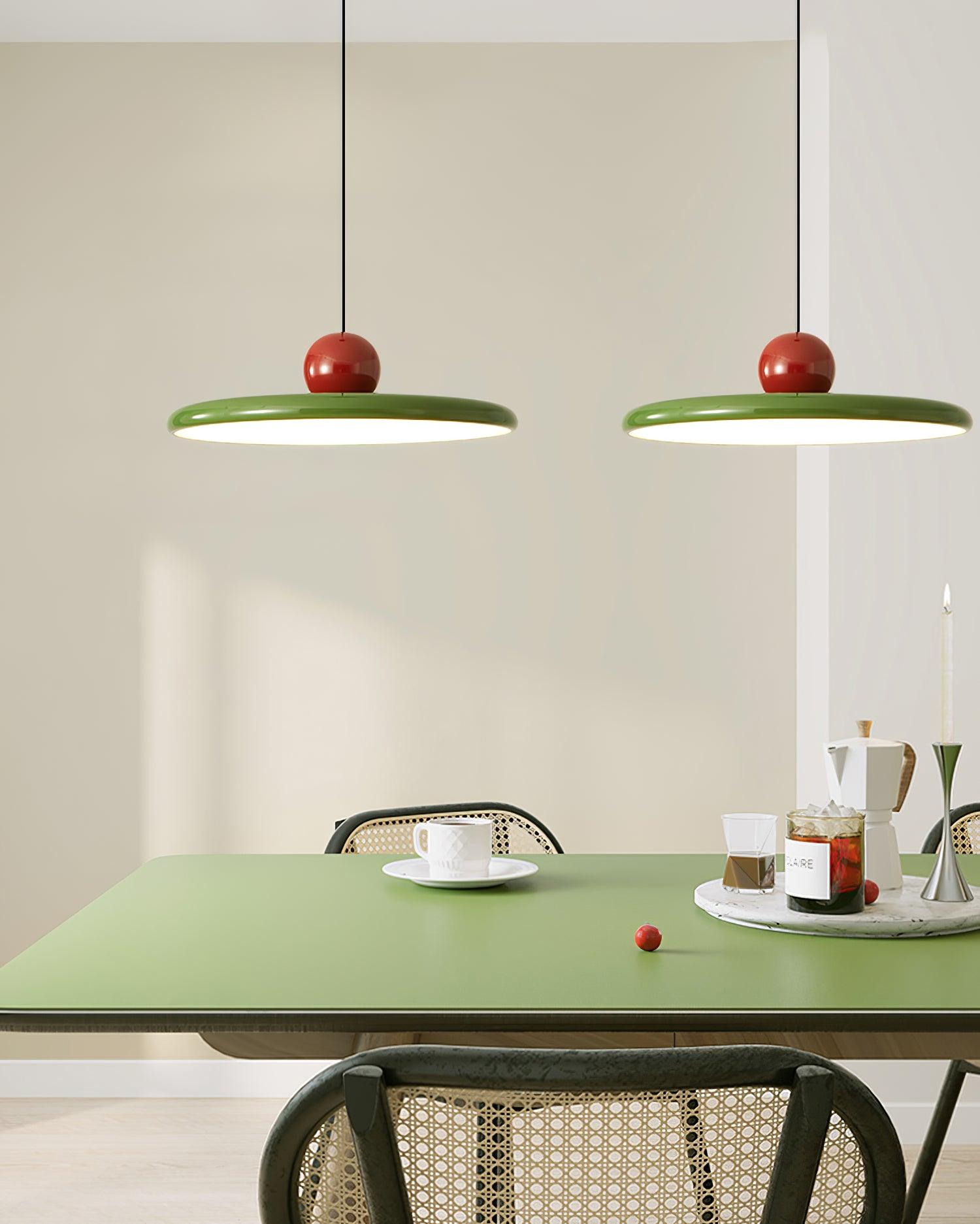 Two Red and Green Lola pendants above a green table