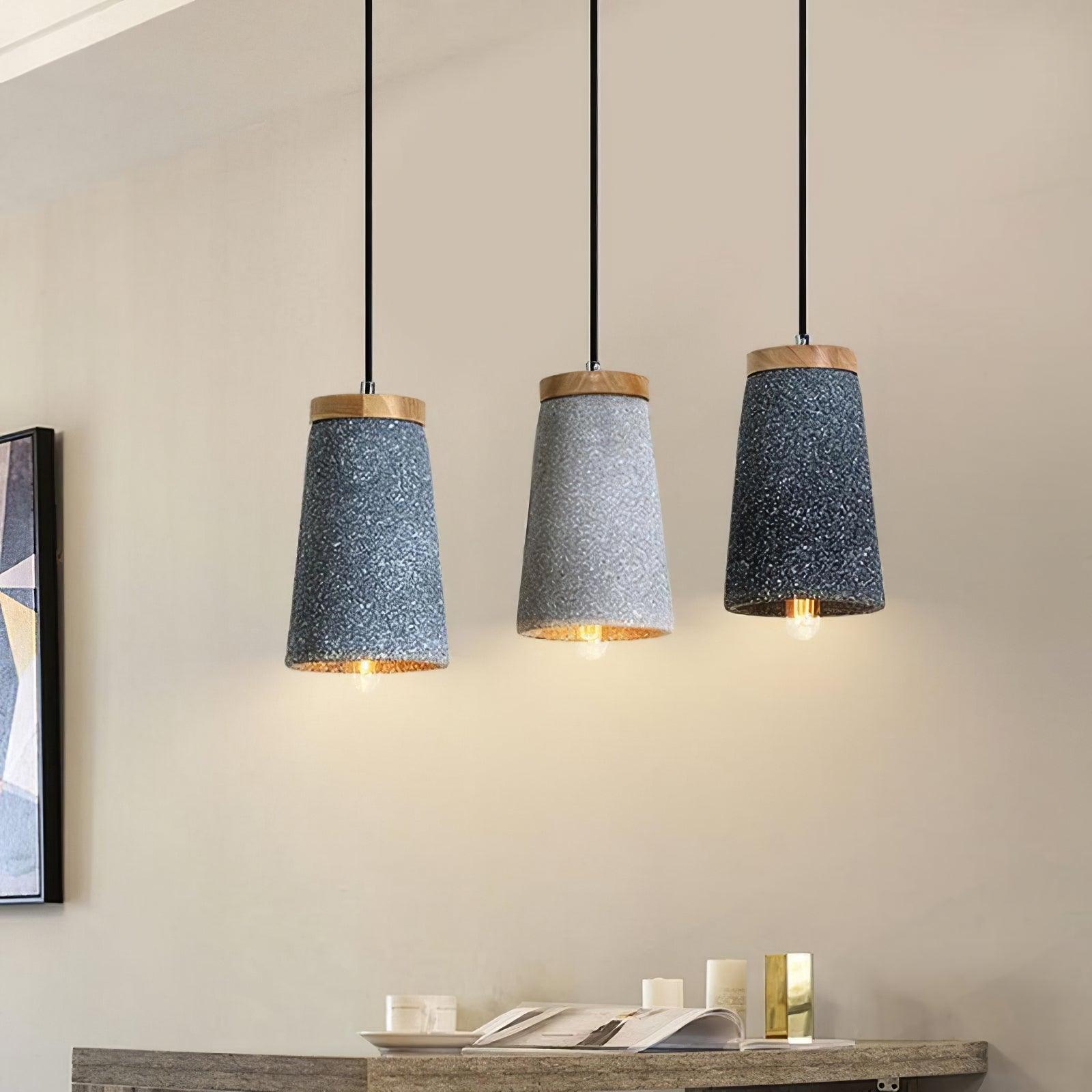 Three wood-topped pendants above a console