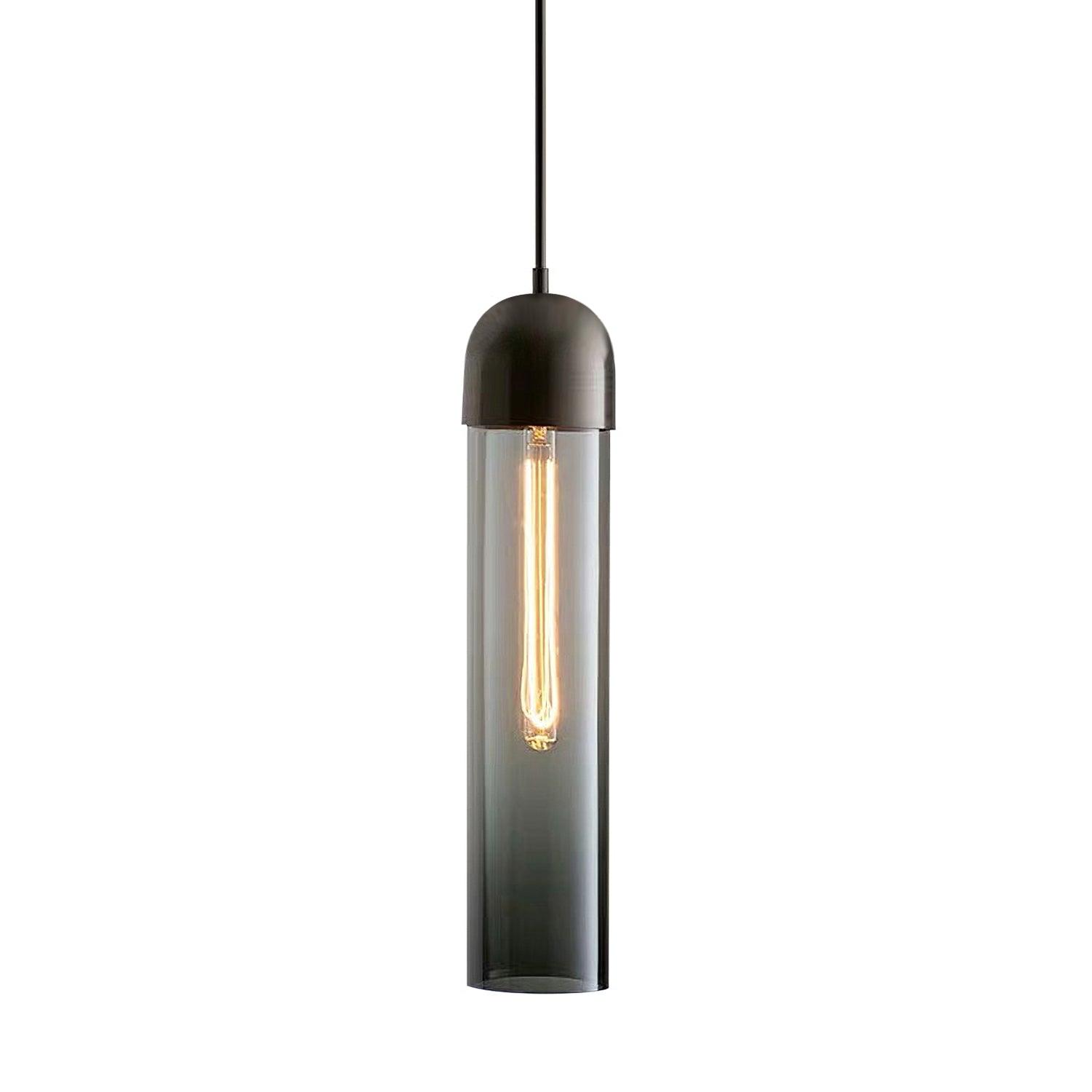 Smoky glass cylinder pendant with dark cap and elongated glowing bulb on white