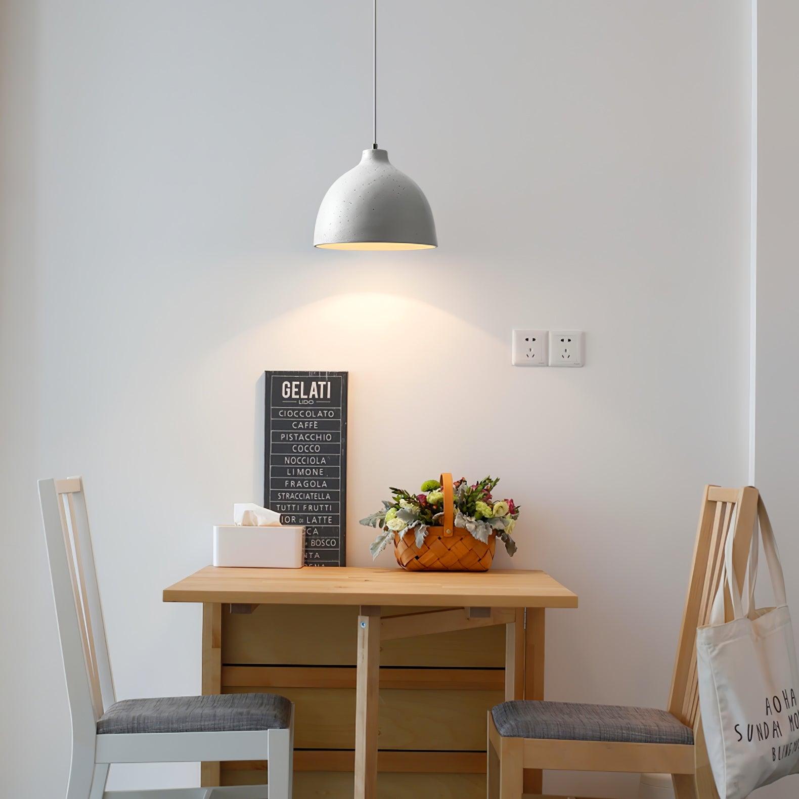 White bowl pendant over a compact dining table