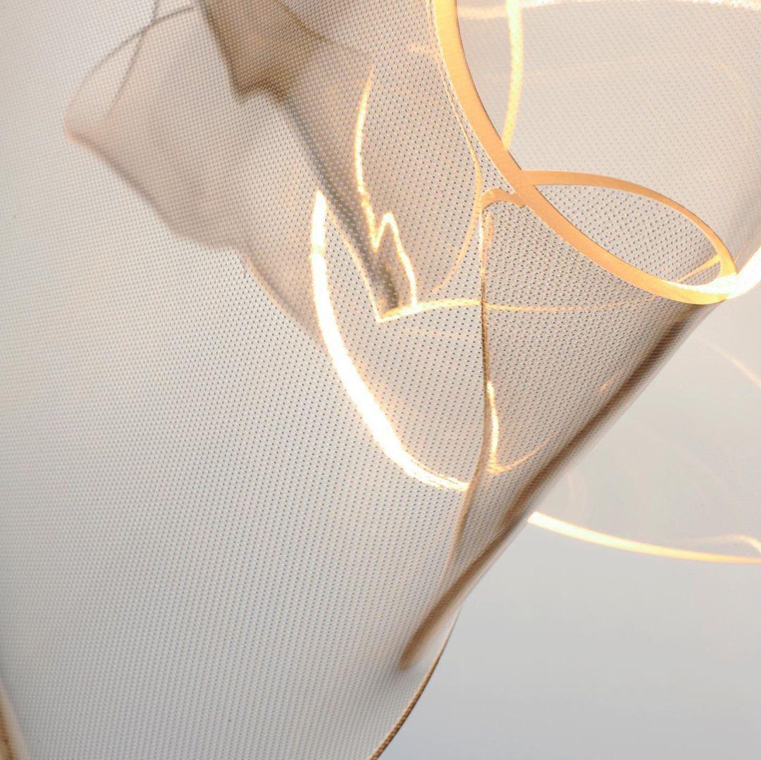 Warm glowing curve along a transparent acrylic surface