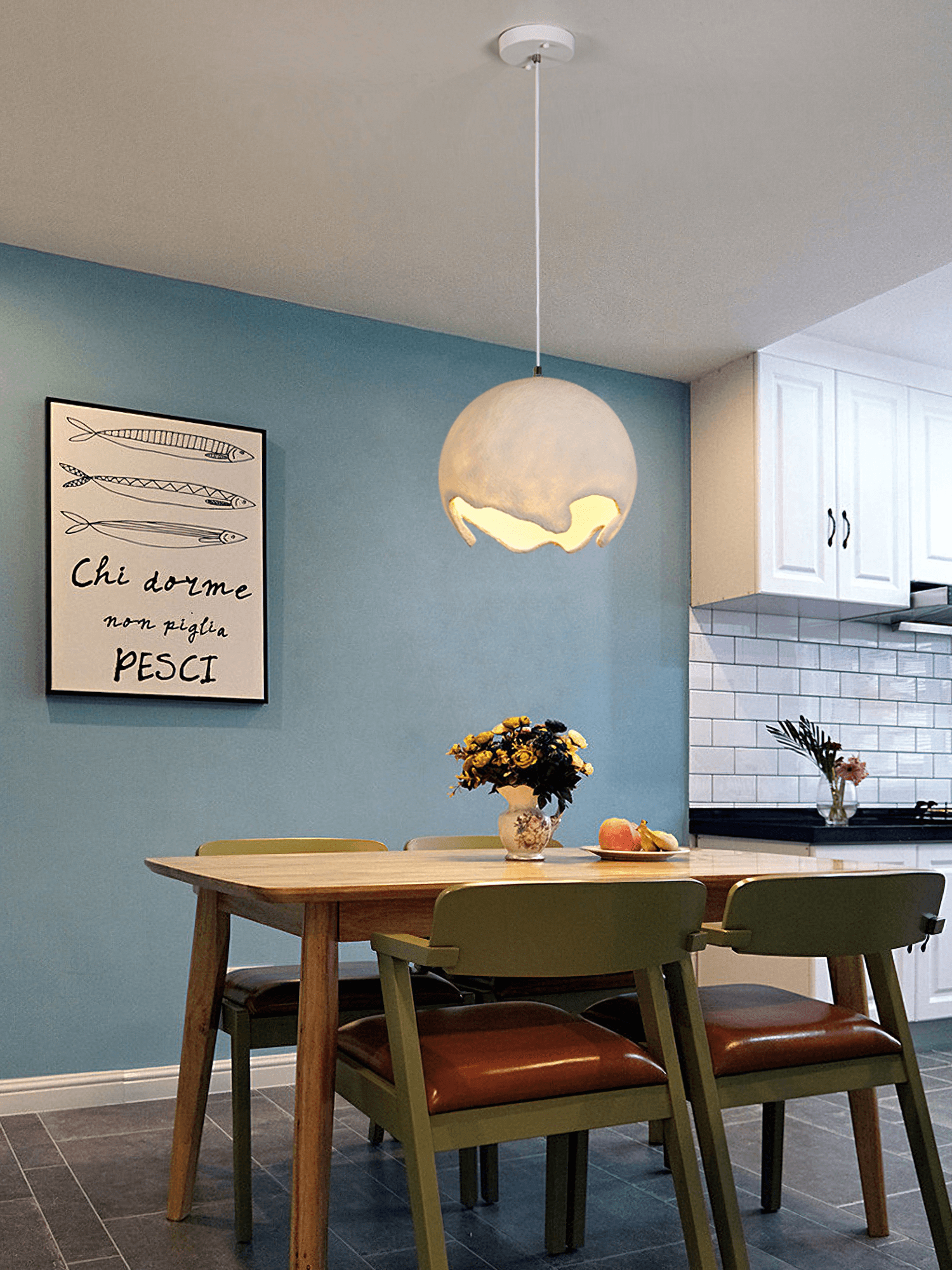 Beige globe pendant above a table beside the kitchen
