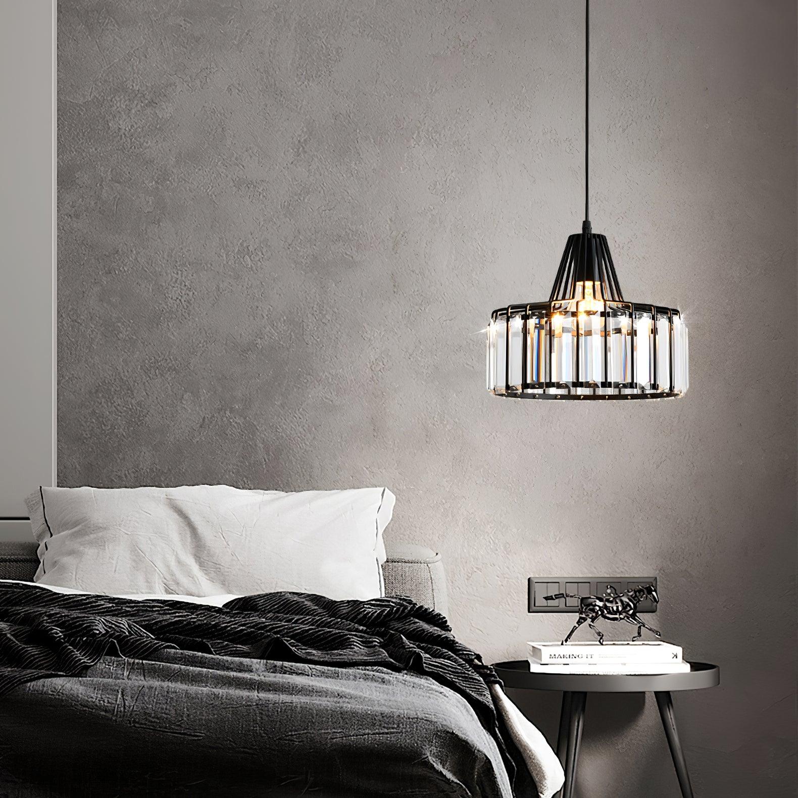 Black drum pendant beside a bed