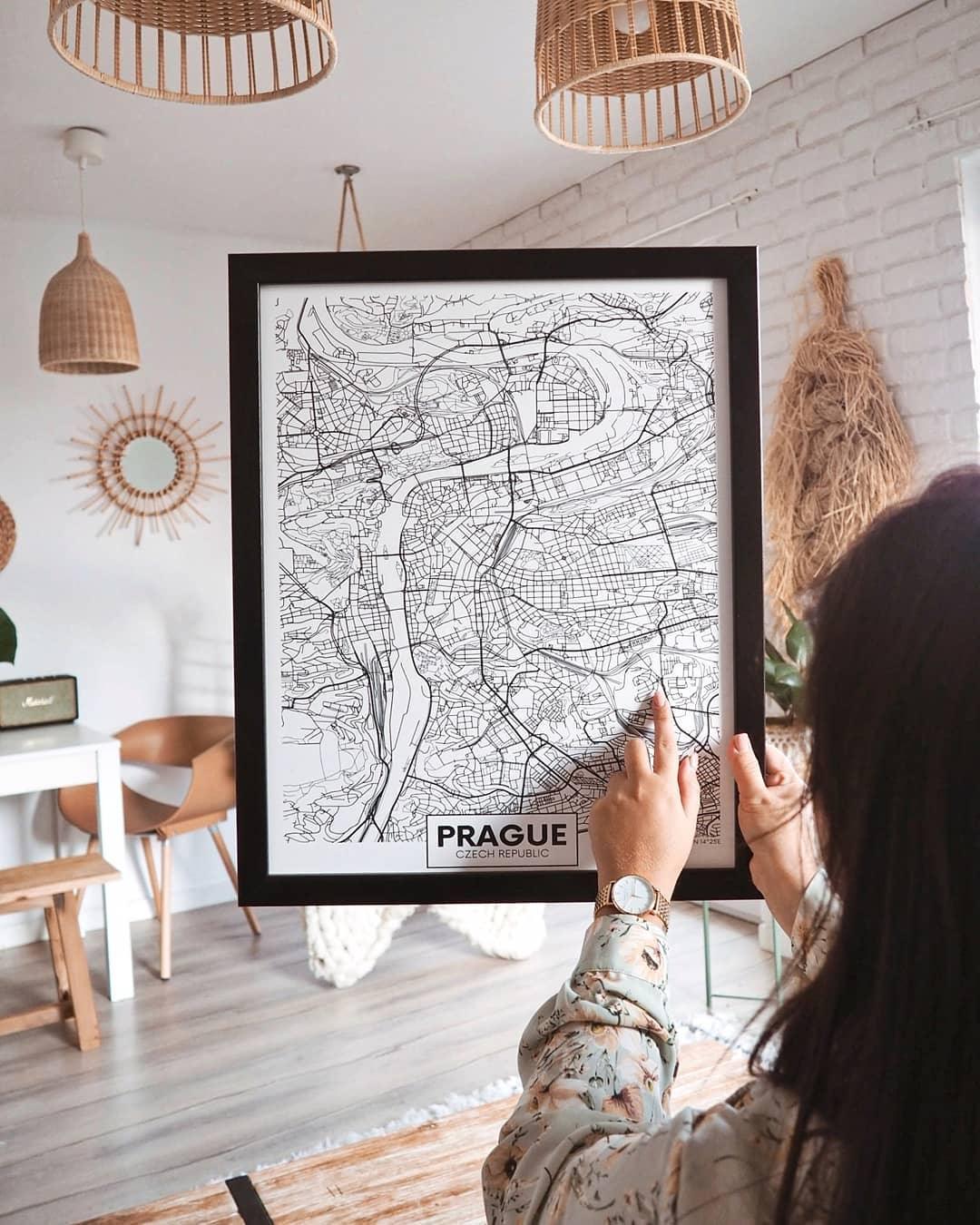 Room scene with woven pendants and a framed Prague print