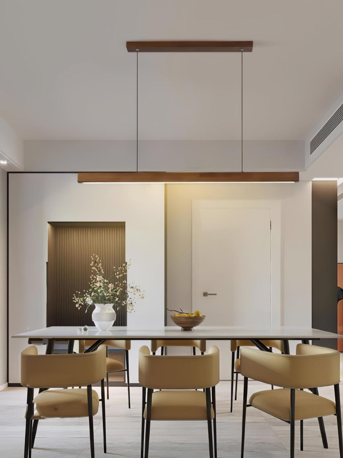 Walnut-colour pendant above a dining table with upholstered chairs
