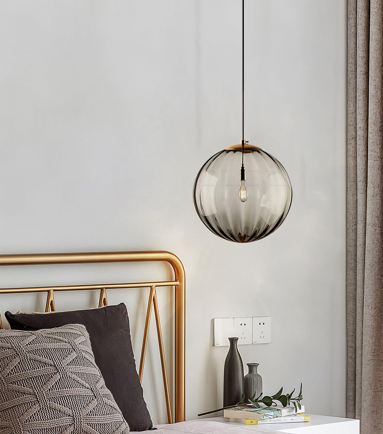 Paola pendant light with a coloured glass globe and small metal cap