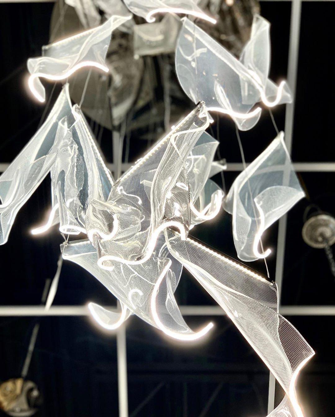 Illuminated wavy edges on a cluster of acrylic elements