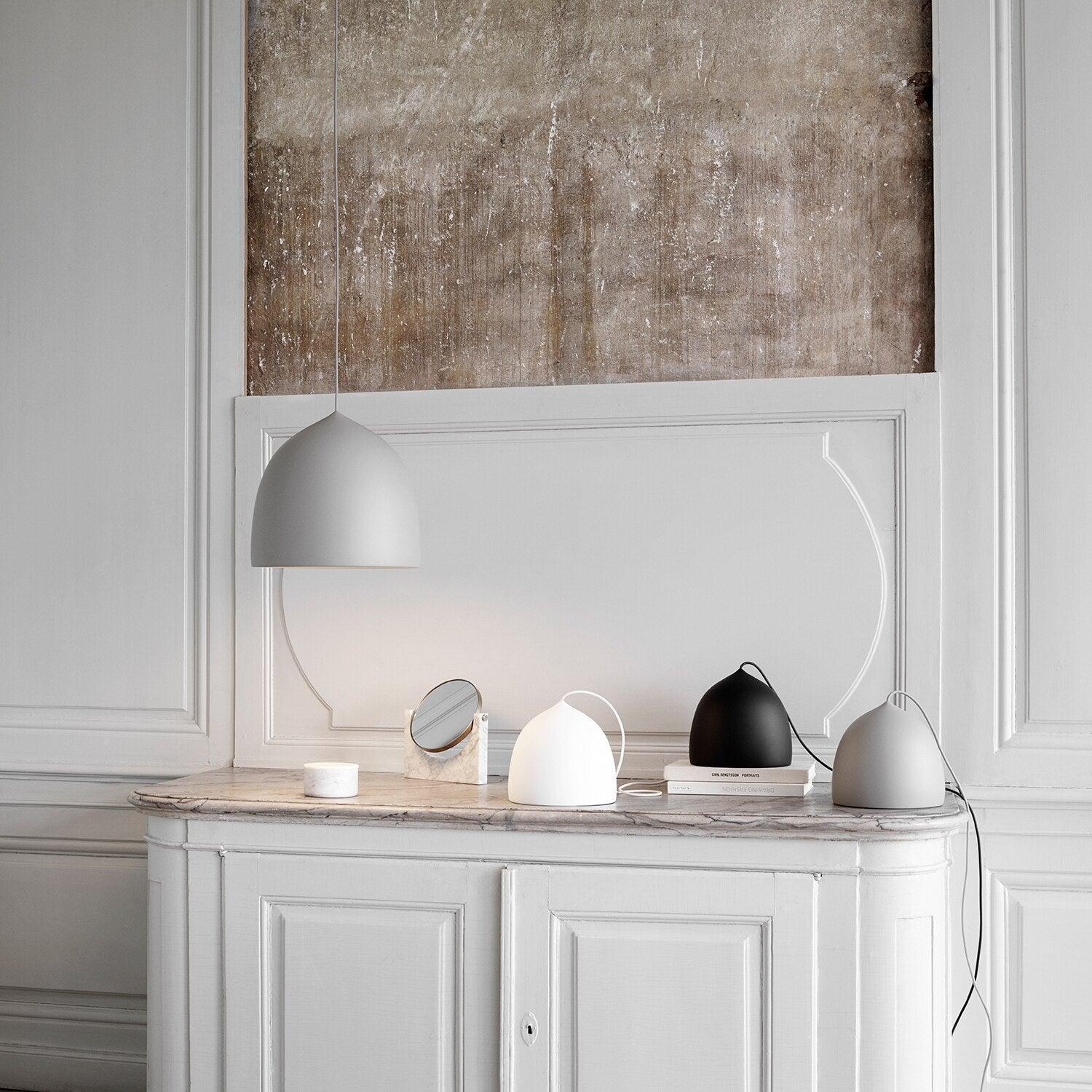 Gallery display of pendant, table and floor lighting forms