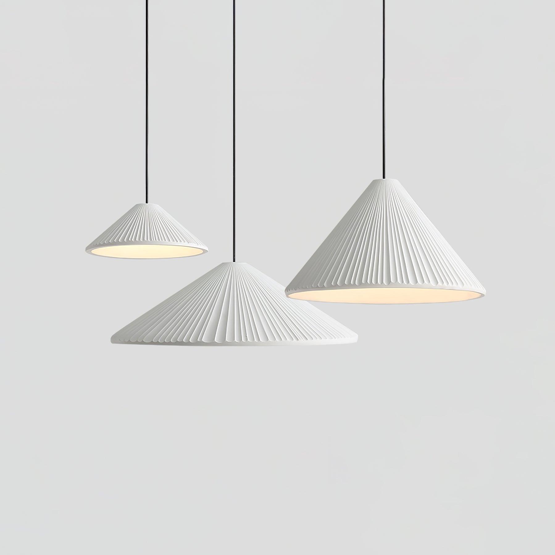 Three White pleated shades at varied heights